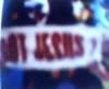 Perky Da Clown Sky diving with sign reading, "GOT JESUS?"